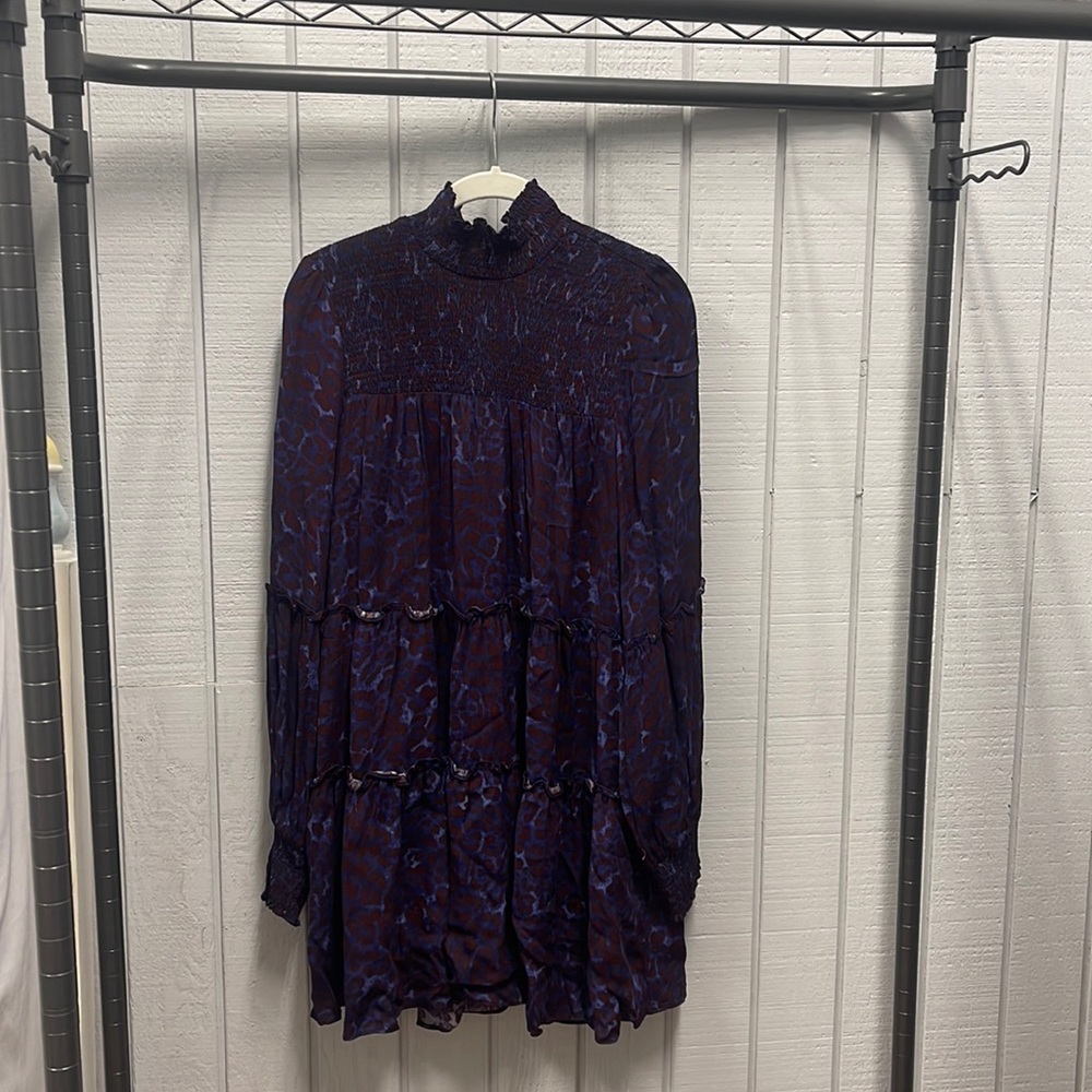 Animal print dress with smocked neck and wrists details.